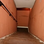 The Haunted House Escape Room London - Haunted House Staircase with Orange Walls