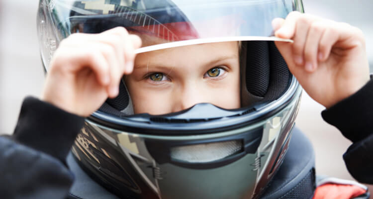 Kid driving off road in full face helmet