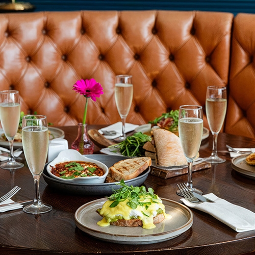 Bottomless Brunch at DoubleTree Metropole drink and food on table in booth thumbnail