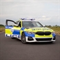 Police car with door open on track