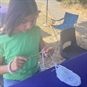Young girl learing how to crochet