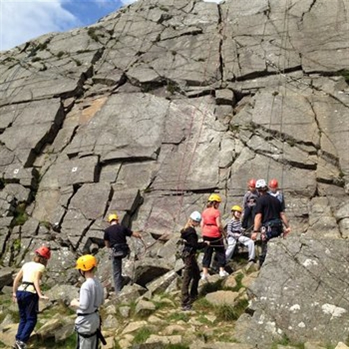 man learning how to rock climb