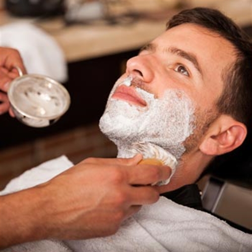 man getting a cut throat shave man getting a cut throat shave