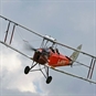 red biplane in flight