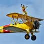 man wingwalking with thumbs up